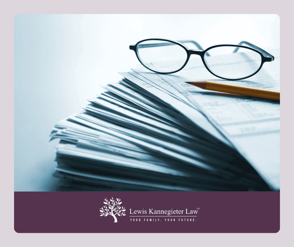 Pile of papers with glasses and pencil